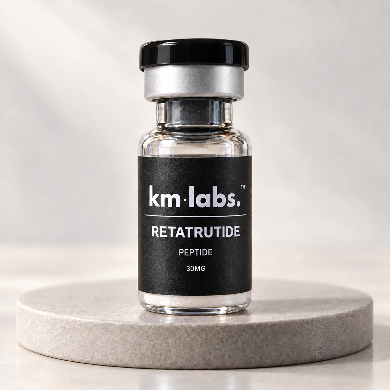 KM Labs Retatrutide research vial on a stone studio plinth